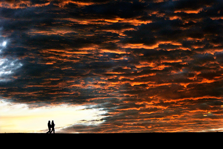 24 hours in pictures: Two men walk along Bennington Lake at sunset 
