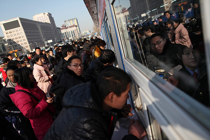 24 hours in pictures: Chinese buy train tickets ahead of the lunar new year
