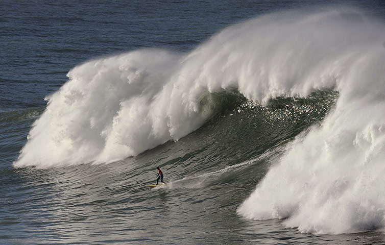 Best of the Week sport: A participant rides one of the 5 metre high waves at Getxo