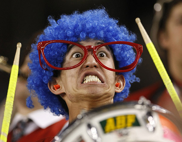 Best of the Week sport: College football fan beats a drum as he attends the 2012 Fiesta Bowl