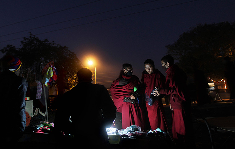 FTA: Altaf Qadri: Buddhist monks shop for sandals from a roadside vendor