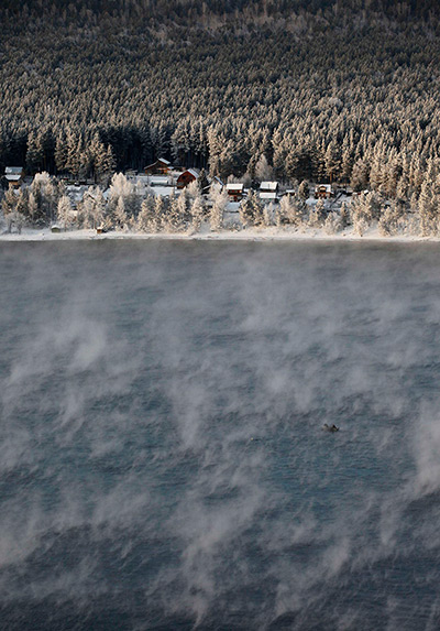 24 hours in pictures: Fishermen sail on a boat through a frosty fog along the Yenisei River