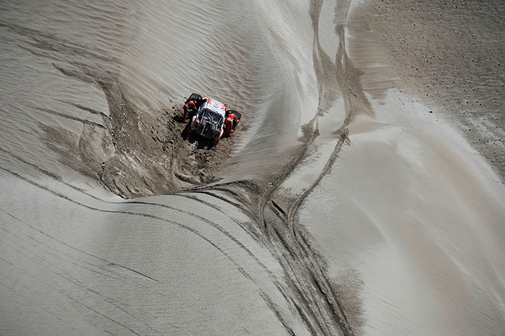 24 hours in pictures: Toyota's drivers try to push their car through dunes at Dakar Rally
