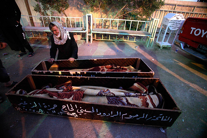 24 hours in pictures: Man grieving over the coffins of his son and daughter, Basra