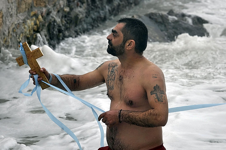 Epiphany: A faithful man retrieves a cross from the sea thrown by a priest