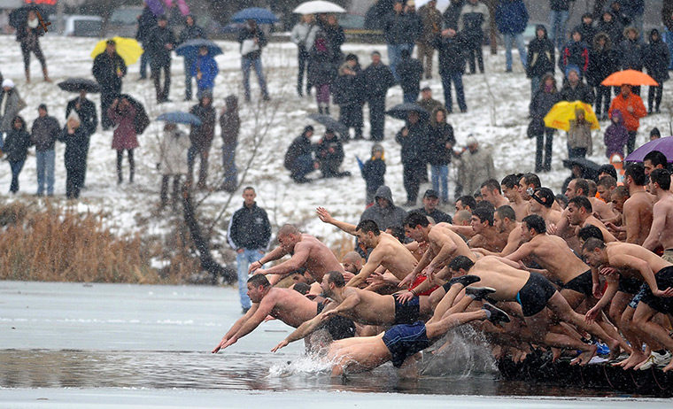 Epiphany: Men jump into a lake in an attempt to grab a wooden cross in Sofia