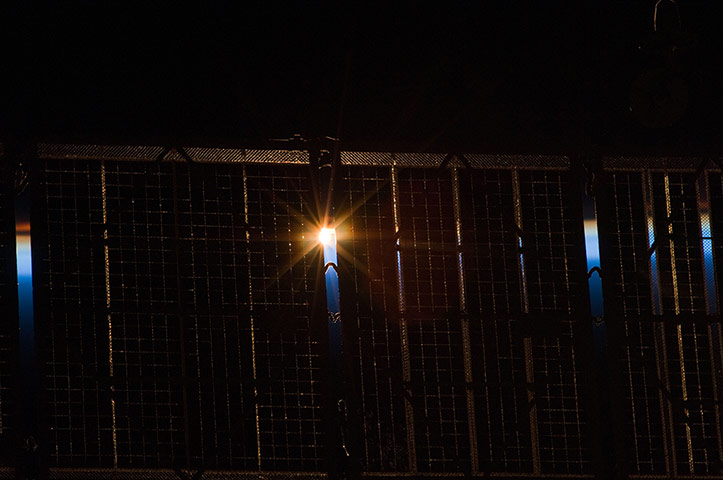 Month in Space: Sun Peeks Through Solar Array from ISS