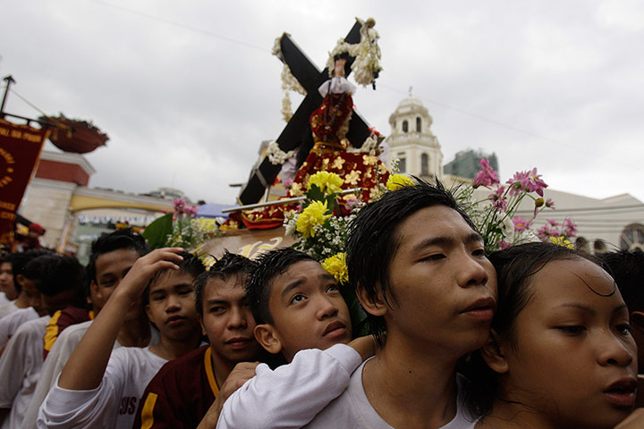 24 Hours: Young Filipino devotees carry a replica of the Black Nazarene in Manila