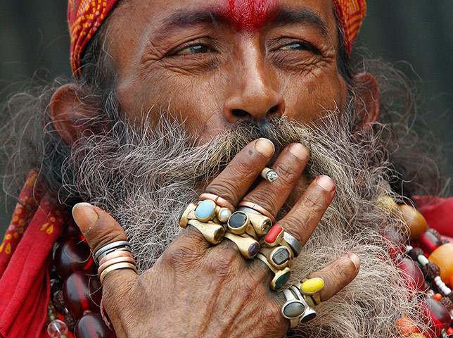 24 Hours: A Sadhu or Hindu ascetic smokes a bidi, a local cigarette, in Kolkata