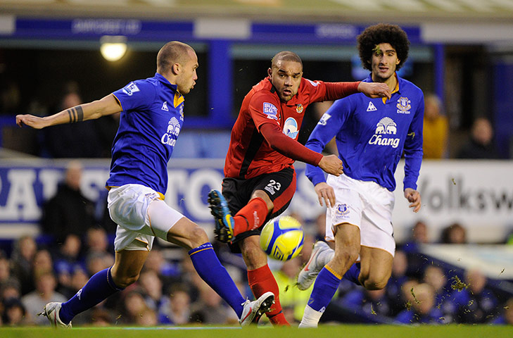 Everton v Tamworth: Lyseden Christie of Tamworth has a shot blocked by Jonny Heitinga