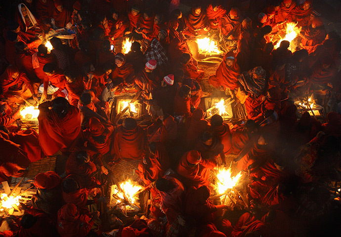 24 hours: Kathmandu, Nepal: Hindu women sit around fires to warm themselves