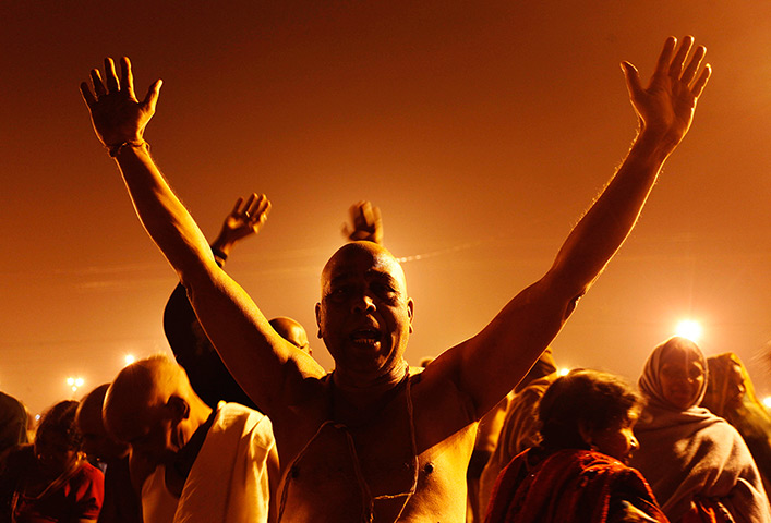 24 hours: Sangam, India: Hindu devotees perform morning prayers