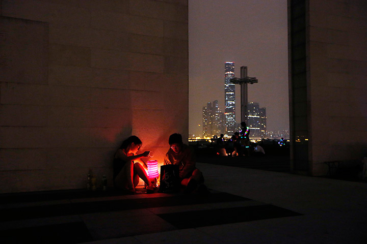 24 hours: Hong Kong, China: A couple lights a lantern during the mid-Autumn festival 