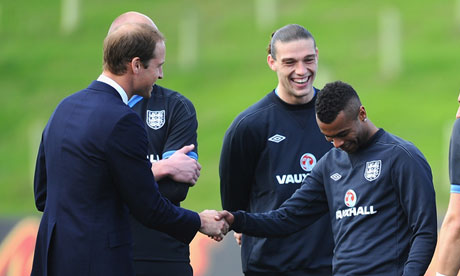 You naughty boy! Prince William jokes with Ashley Cole at St George's Park.