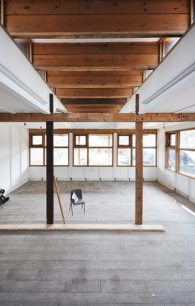 Oasis Childrens' Venture: An empty space showing concrete floor and wooden timbered structure
