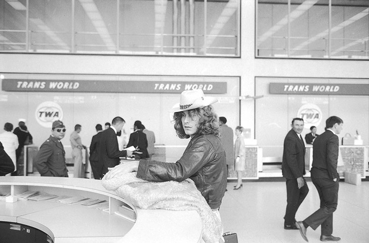 Led Zeppelin: Led Zeppelin lead singer Robert Plant standing at counter