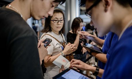 A man (L) gets his passport checked by a