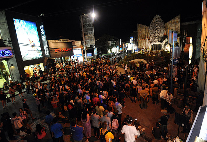 Bali anniversary: Foreigners and local people gather at a memorial monument in the Kuta