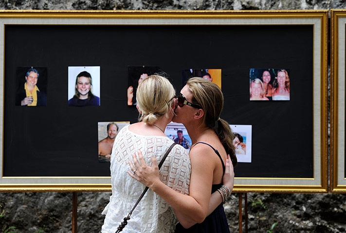 Bali anniversary: Friends and relatives pay their respects at picture boards of the victims