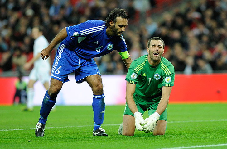 Tom England 3: San Marino captain Della Valle pats keeper Simoncini after a save