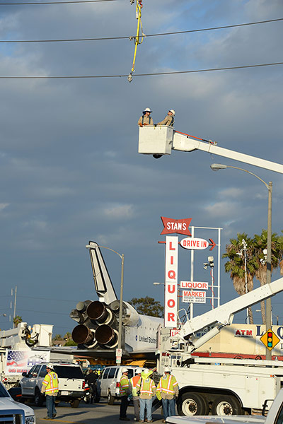 Endeavour: Utility workers prepare to lower utility