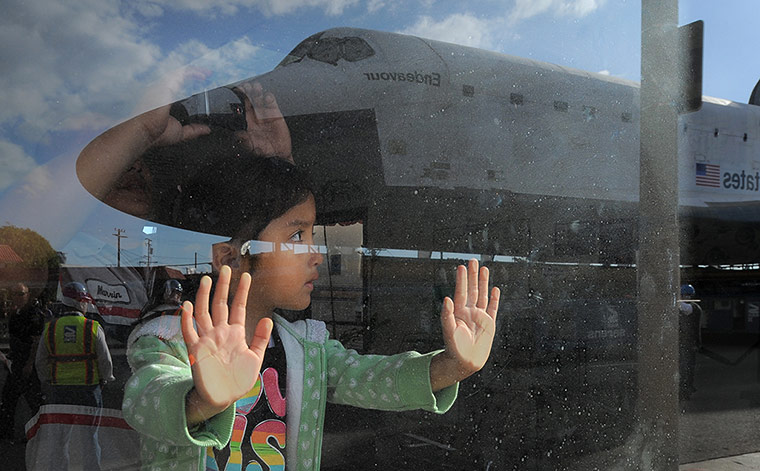 Endeavour: A young spectator watches as the Space Shuttle Endeavour moves slowly past