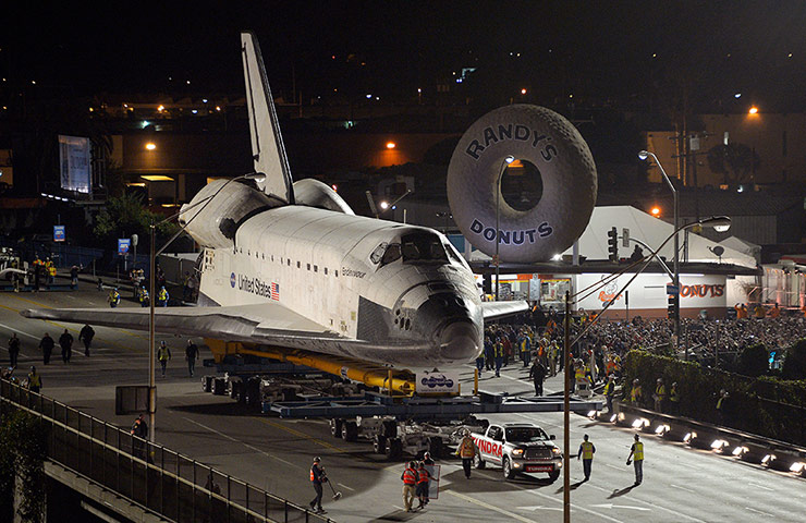 Endeavour: The Space Shuttle Endeavour is slowly moves past Randy's Donuts