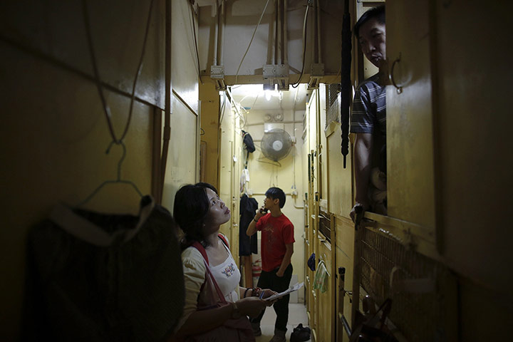 Twenty Photographs: NGO worker speaks to people living in wooden boxes in Hong Kong