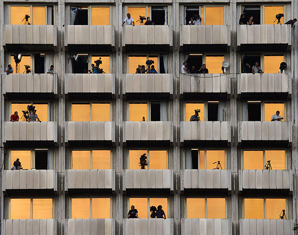 Twenty Photographs: Media crews use apartment balconies to cover Merkel visit