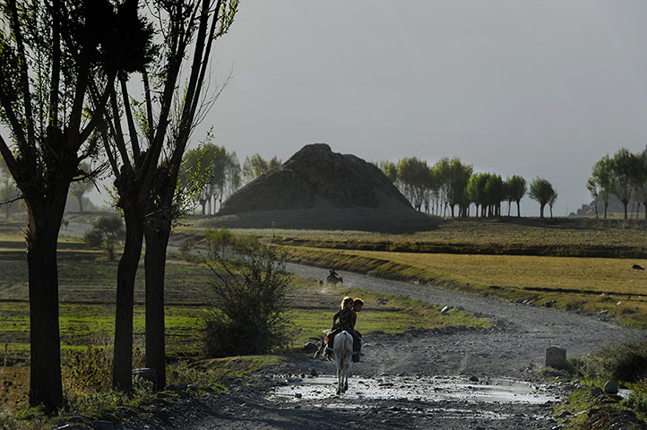 Twenty Photographs: An Afghan boy and a girl ride a donkey in Afghanistan