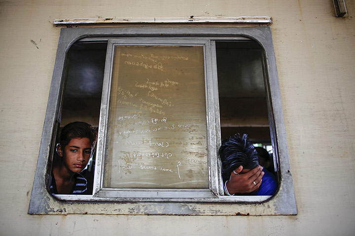 Twenty Photographs: People look from a circular train as it stops at a station in Yangon
