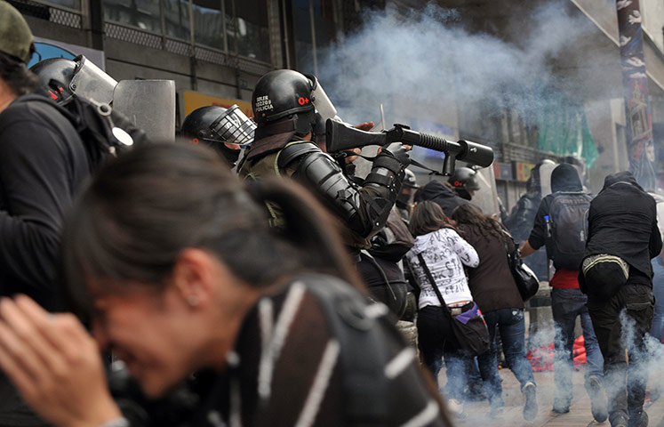 Twenty Photographs: Riot police throws tear gas at protester