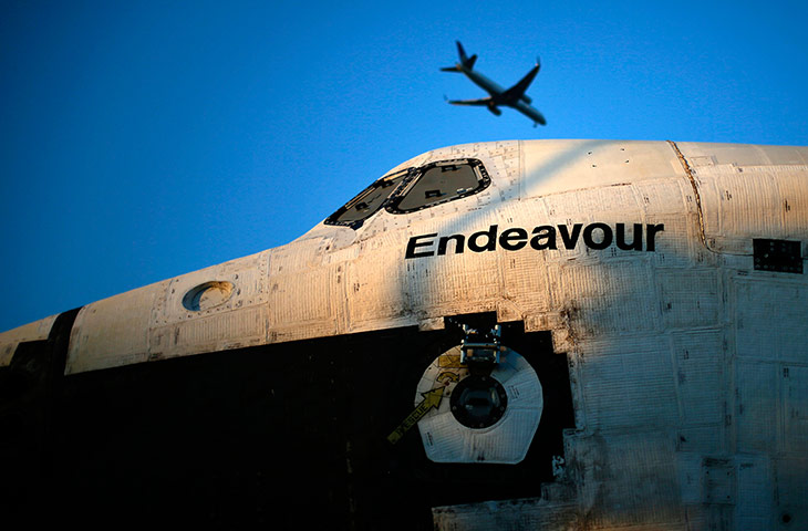 Space Shuttle: A plane flies over the space shuttle