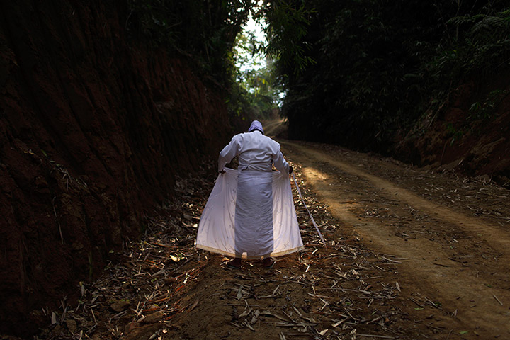 24 hours: Apuan, Bali. Indonesia: A Balinese man adjusts his clothes