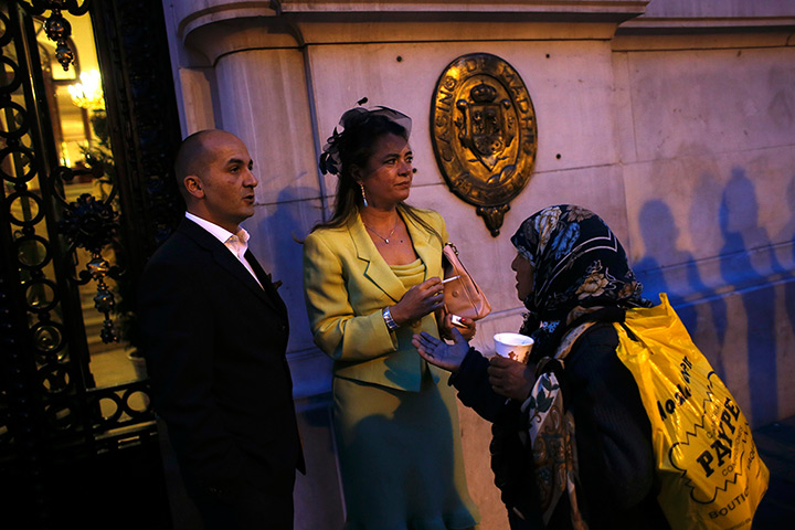 24 hours: Madrid, Spain: A woman asks a couple for alms