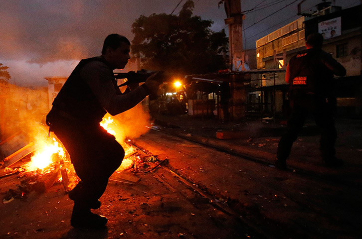 24 hours: Rio de Janeiro, Brazil: A police officer in Jacarezinho slum