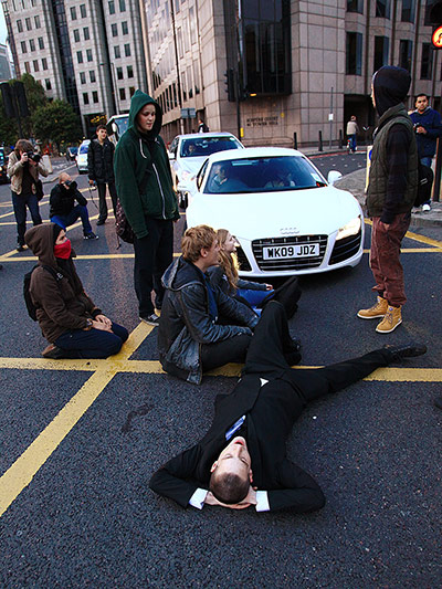 Global Noise Protests: A protester briefly blocks a road near Tower Bridge in London