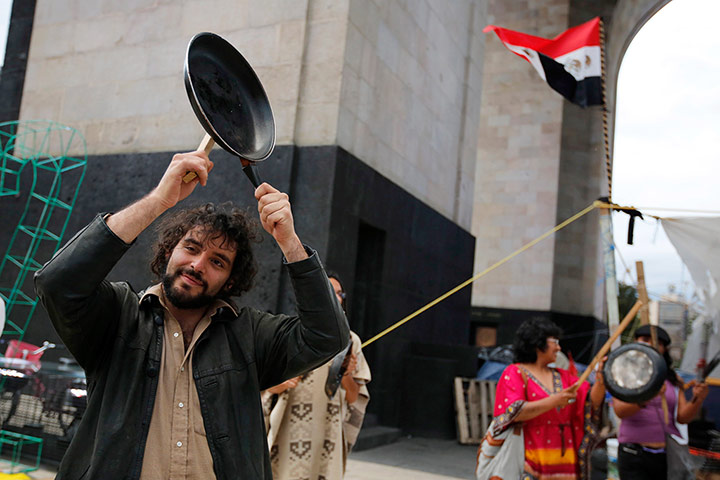 Global Noise Protests: A demonstrator bangs a saucepan with a spoon in Mexico City