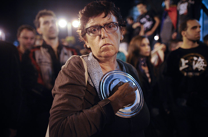 Global Noise Protests: A woman marches in protest against the payment of bank's debts