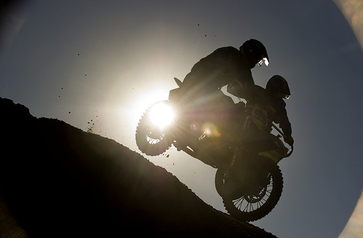 beach race: Daniel and Joe Millard jump over the crest of a dune