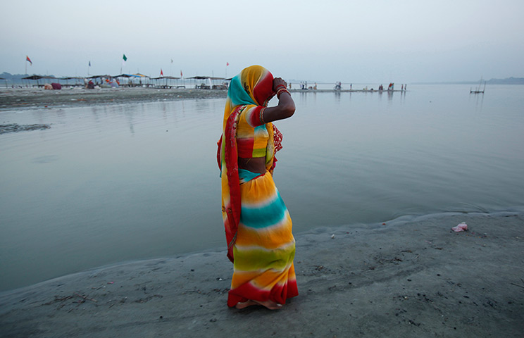 24 hours: Sangam, India: A Hindu devotee arrives for a dip