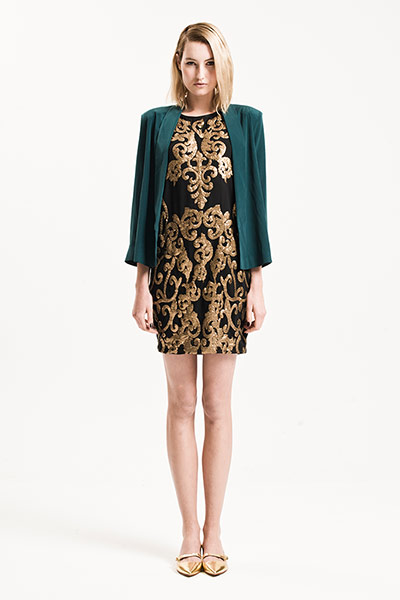 All Ages: Baroque: Model wears black and gold baroque dress and jade cardigan