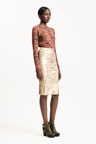 All Ages: Baroque: Model wears rust coloured top and gold skirt both in a baroque style