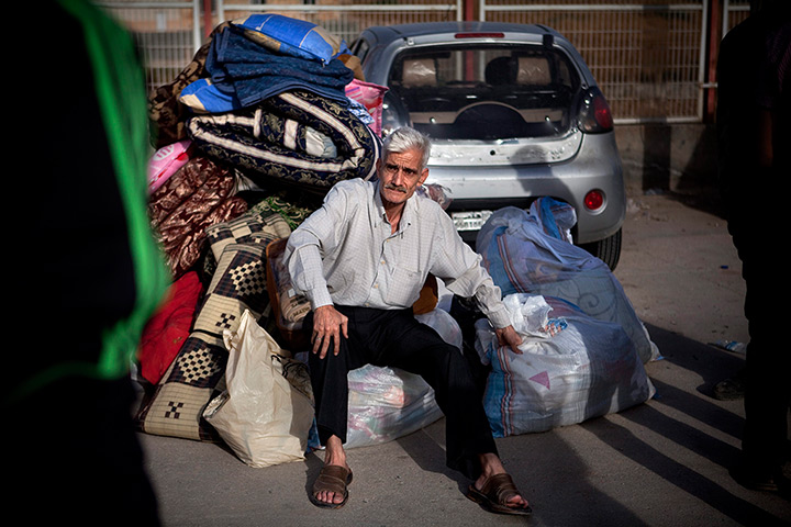 FTA: Maysun: A Syrian refugee sits on a pile of belongings