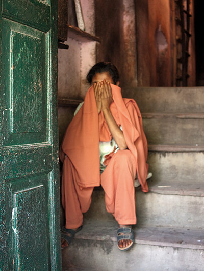 David Bailey's India: Woman sitting on the steps of a doorway