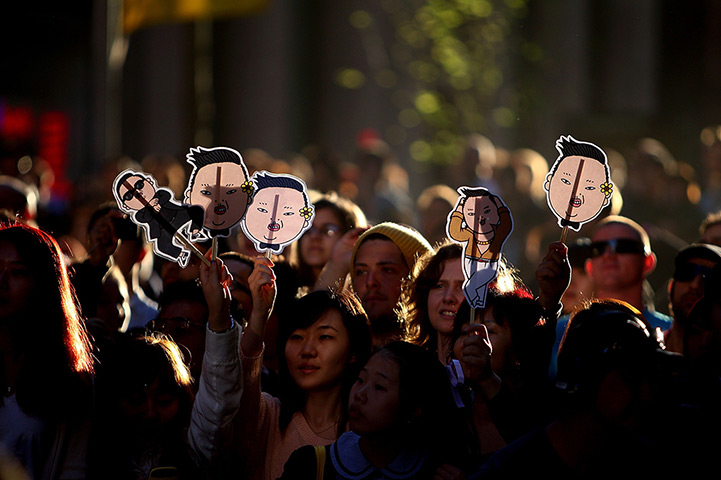 24 hours: Sydney, Australia: Fans hold up signs as rapper Psy performs