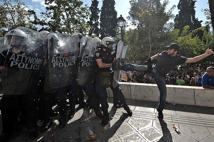 Greece protests: A demonstrator clashes with riot police