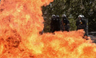 A fireboomb explodes in front of the riot police during clashes with demonstrators in Athens