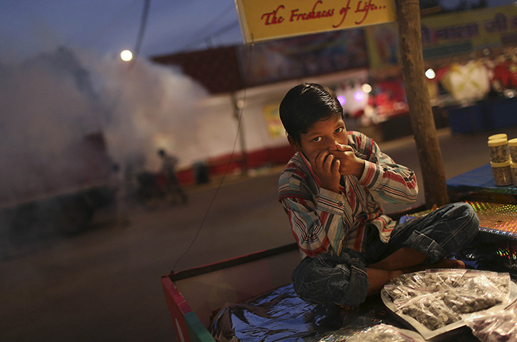 24 hours: New Delhi, India: An Indian boy covers his nose 