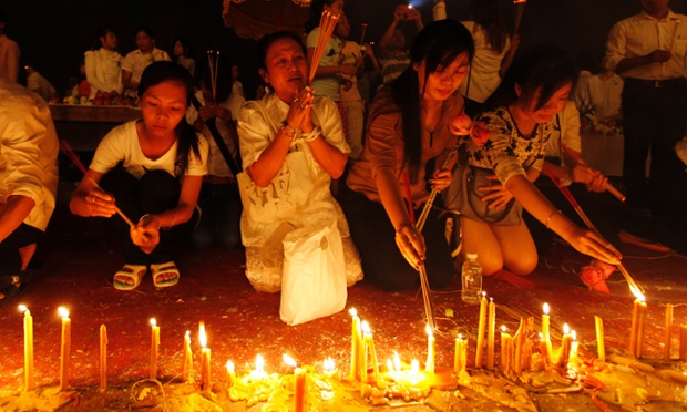 Cambodians burn incense sticks and pray for their former king Norodom Sihanouk, in front of the Royal Palace in Phnom Penh. The nation has been mourning the former king, who abdicated the throne in favour of his son in 2004, since his death on Monday in Beijing, China, at the age of 89